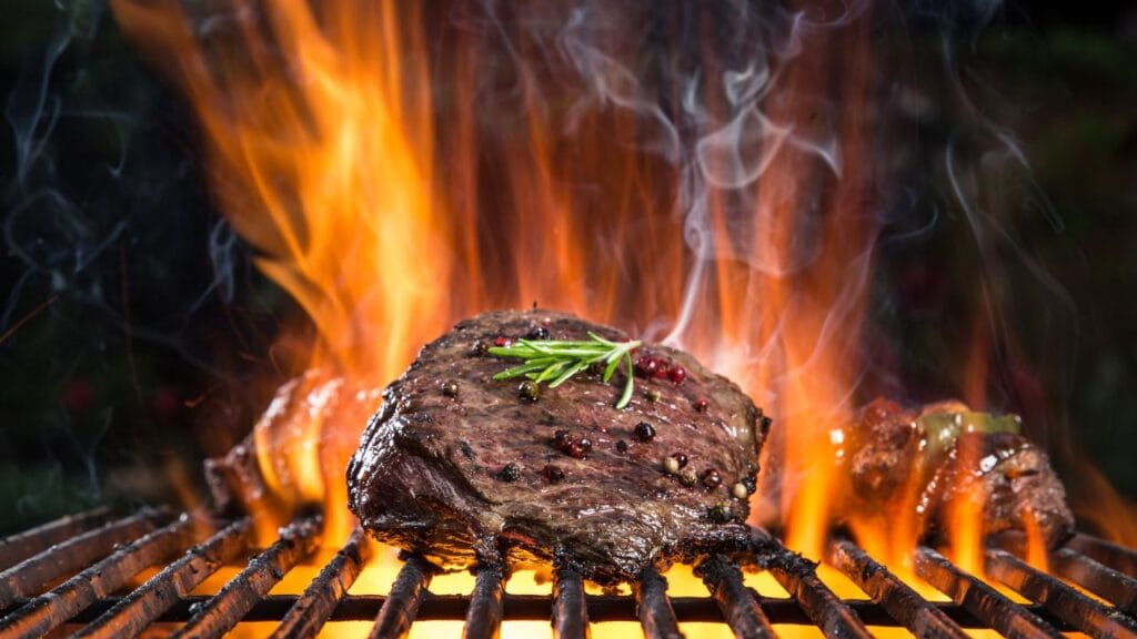 A perfectly grilled steak on a wooden cutting board with herbs and spices, showcasing cooking tips for optimal flavor.